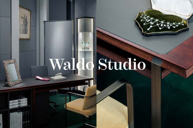 Architecture and Interior branding and identity image for Waldo Studio featuring a refined jewellery showroom for Wartski St James with dark wood furnishings, illuminated display cases, and close-up details of custom materials and craftsmanship, with the Waldo Studio logotype overlaid.